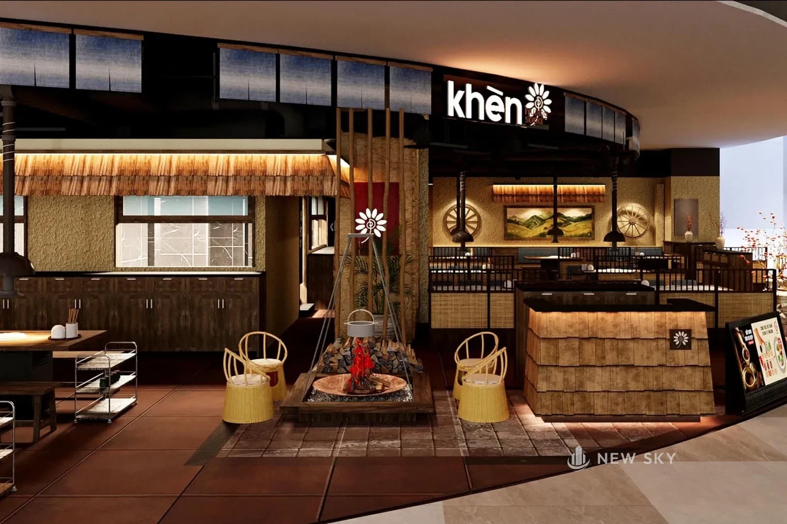 Phối cảnh nhà hàng Khèn Nướng Sapa tại Aeon Mall Hạ Long nhìn từ hành lang: giữa sàn là khu bếp lửa giả với khay củi và khung sắt treo ấm nước, mỗi bên hai ghế mây; bên phải là quầy thu ngân ốp gỗ tà vẹt có hình bông hoa; phía trên là biển chữ "khèn" kèm bông hoa, dải rèm màu chàm và dải mái gỗ trên tường.